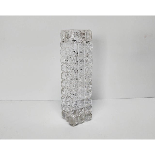 Square glass bud vase with studded grid texture to catch the light.