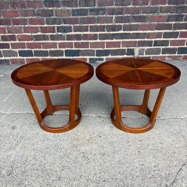These side tables made by Lane Furniture feature a multi-panel solid walnut round top with a round tapered base. Serial no...