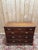 An 18th-century English chest of drawers in solid oak, Georgian style, circa 1740-1780. It features a configuration of...