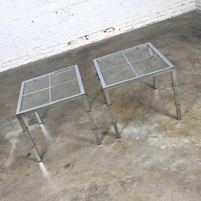 Spectacular Hollywood Regency chrome & glass square end tables with brass details in the style of Maison Jansen. Beautiful...