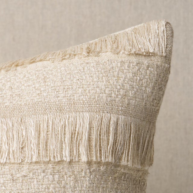 This pillow features Acadia with a knife edge finish. A horizontal fringed stripe, this pattern derives from a textile in...