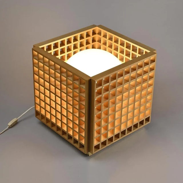 Wooden structure parquet lamp in the shape of an openwork cube retaining a white opalin glass globe. It is based on a...