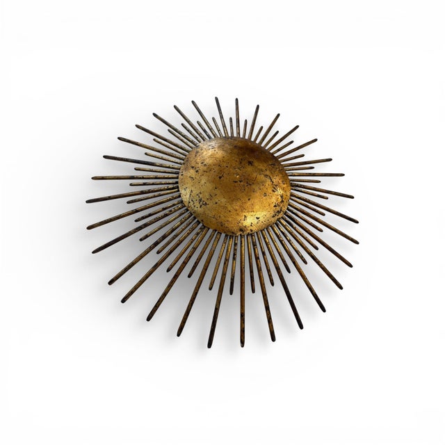 A striking 20th-century Spanish iron light fixture, showcasing the bold craftsmanship and rustic elegance characteristic...