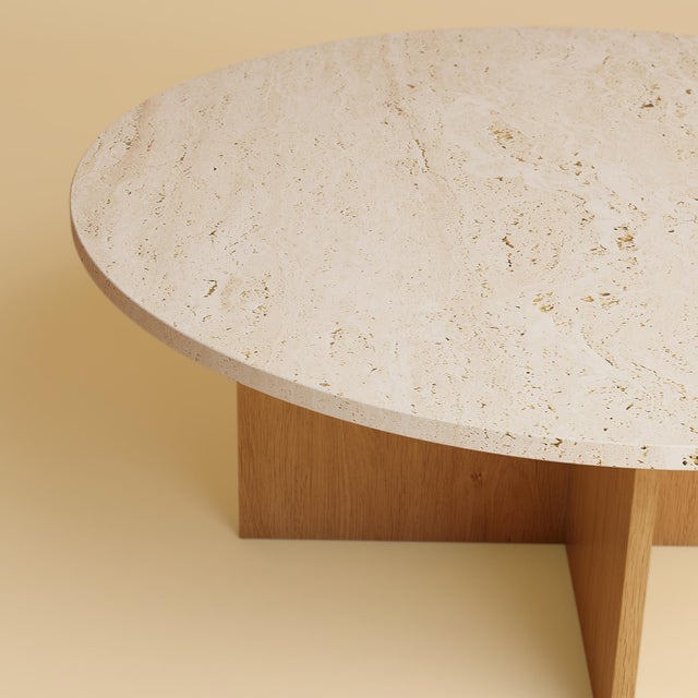 The Hirado is a Roman travertine and oak coffee table, a low table for the space in front of a sofa in which a travertine...