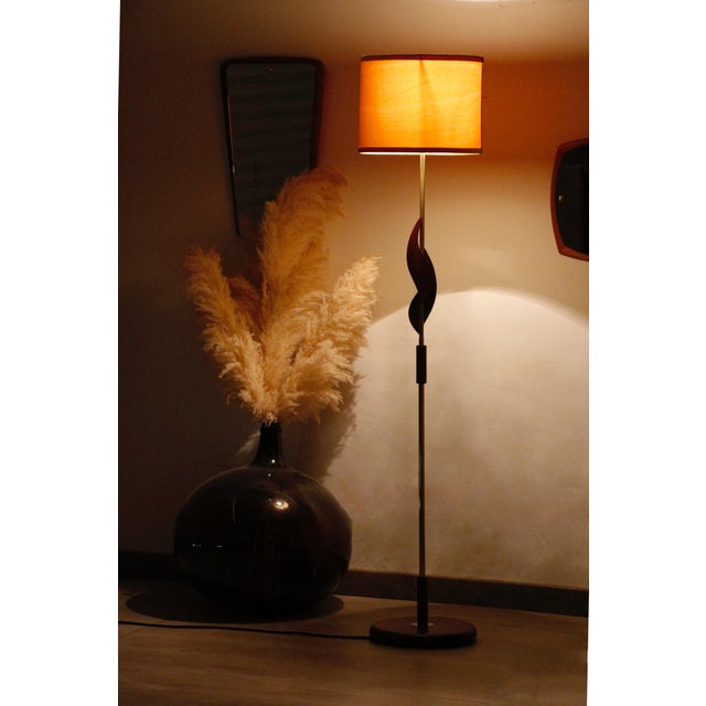 Scandinavian Teak and Brass Floor Lamp: The Vintage Charm of the 1960s This Scandinavian teak and brass floor lamp...