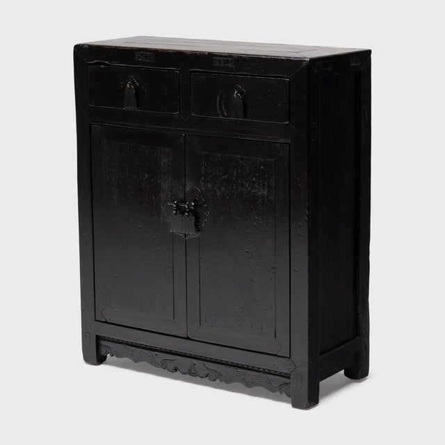 Crafted of elm with traditional joinery, this antique Chinese side cabinet marries simplicity of form with a touch of...
