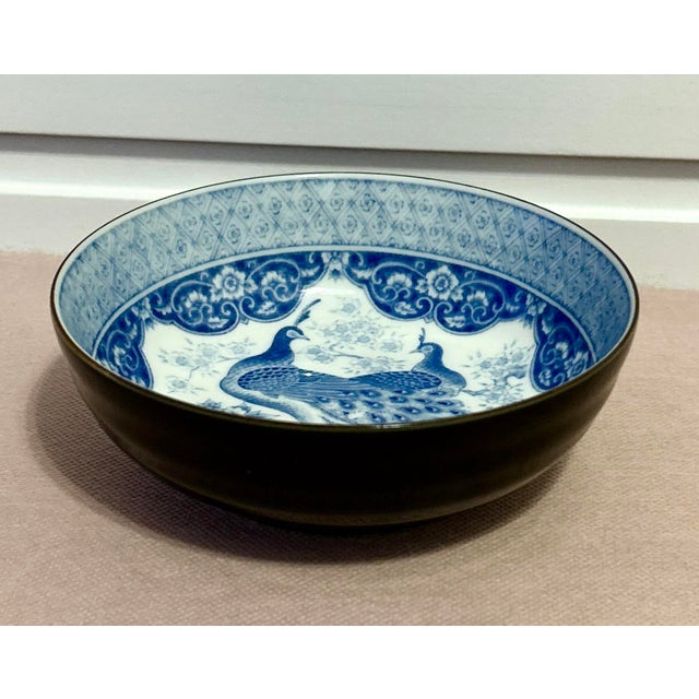Antique blue and white Japanese bowl. Beautifully hand painted blue and white peacocks adorn the center and interior of...
