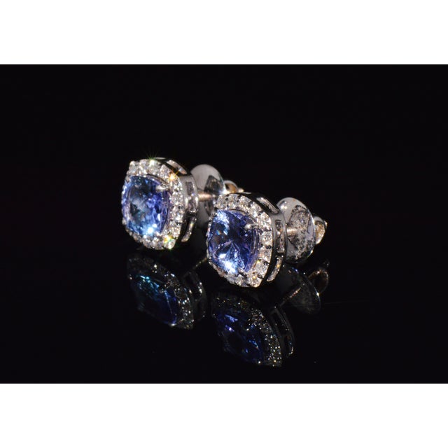 Gorgeous 18K solid gold 2.35CTS diamond and tanzanite stud earrings. These earrings feature a very elegant halo cluster...