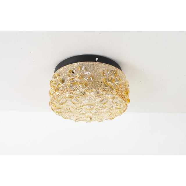 Playful and fun original 1970’s amber glass wall or ceiling lamps by Erco. Made in Germany during the 1980’s. Fantastic...