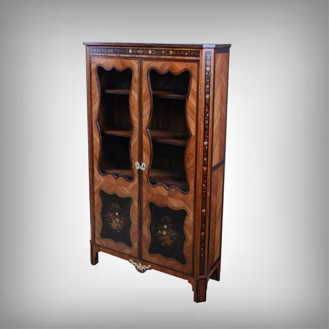 This exquisite glass-fronted bookcase embodies the refined craftsmanship of 19th-century Parisian workshops. It captivates...