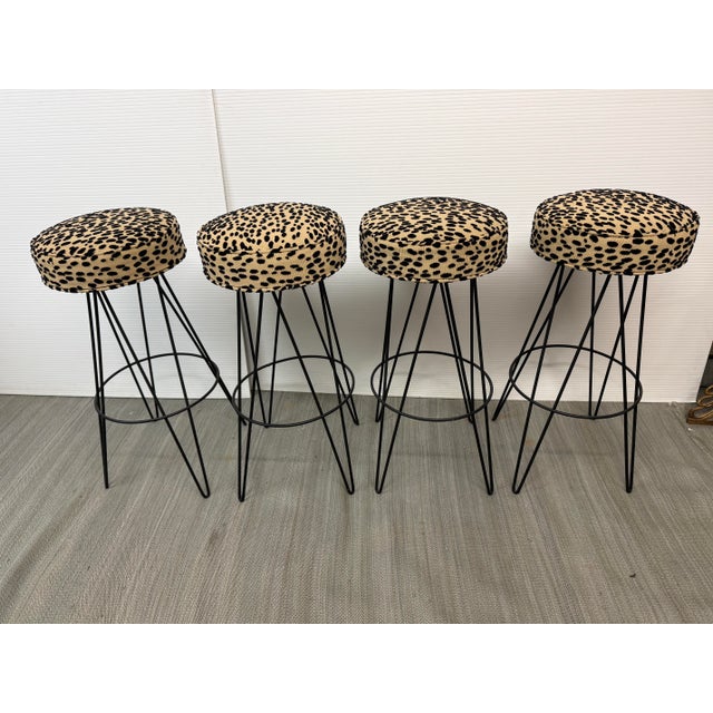 Design Plus Gallery presents a Set of Bar Stools from the Mid 20th Century. They have metal frames that are black with an...