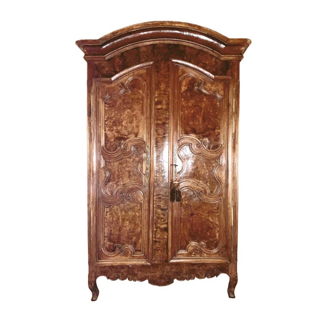 An exceptional 18th century French period Louis XV armoire handcrafted of indigenous old growth walnut and burled walnut...