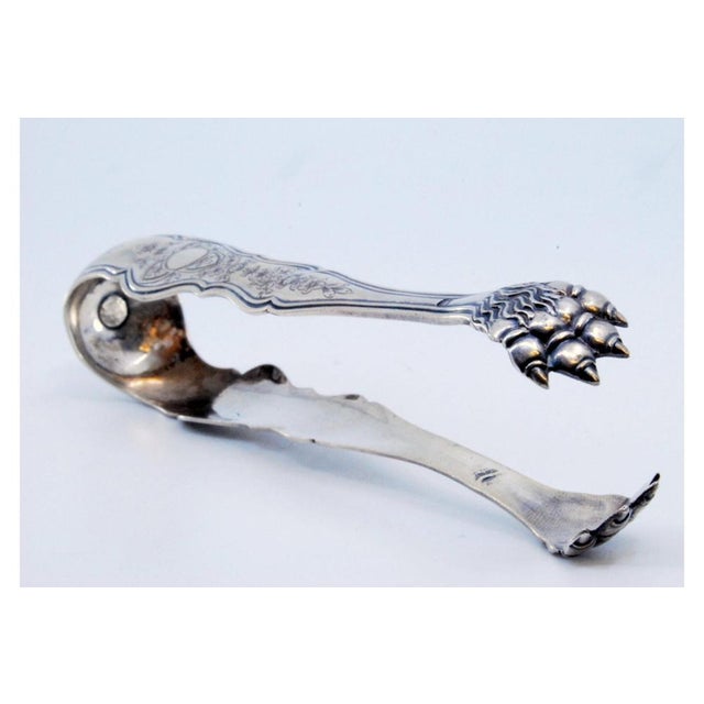 Claws-Shaped Silver Ice Tongs with Engraved Plant Motifs, in Very Good conditions. Designed before 1890 This piece has an...