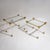 Two rectangular coffee tables with faceted column legs featuring stylized brass capitals and bases. The tabletops are...