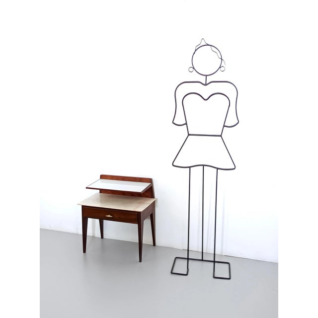 Made in Italy, 1950s. This nightstand is designed in the style of Giò Ponti and it features an ebonized beech frame with a...