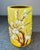 Yellow glazed brushpot with applied decoration of a blossoming plum tree in tones of brown and white.