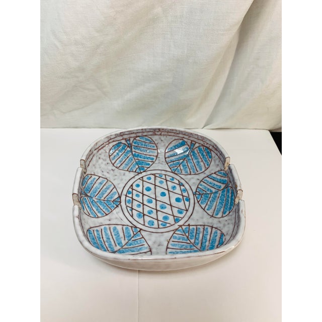 This mid-century modern Bitossi ceramic ashtray designed by Aldo Londi features a distinctive hand-carved leaf and...