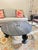 The Anthropologie Caria Coffee Table features a substantial solid marble top paired with a sculptural handcarved mango...