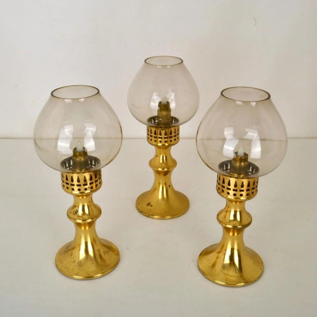 Set of three brass lantern candle holders with glass diffusers, Scandinavian 1960's, for indoor and outdoor use. They have...