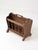 A charming Colonial Revival magazine rack crafted in warm-toned wood, featuring delicately turned spindle sides and softly...