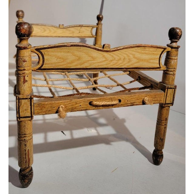 19th century Original paint decorated doll bed from Lancaster County,Pennsylvania in fine as found condition.