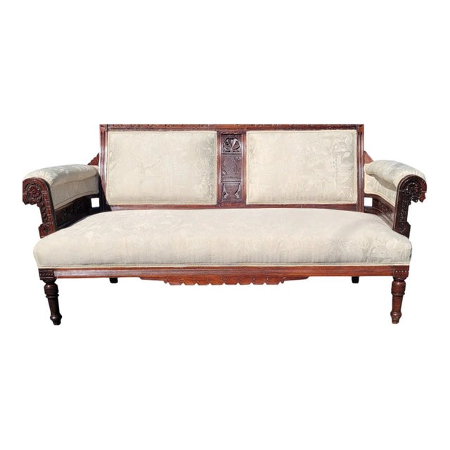 Solid 19th century American Eastlake loveseat made of walnut wood. Fully refurbished with new beige upholstery and Lacquer...