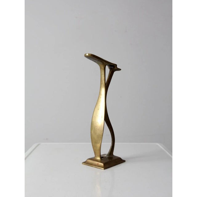 This is an antique brass shoe rest stand. The decorative cobbler display is solid brass with curving lines. Hole in the...