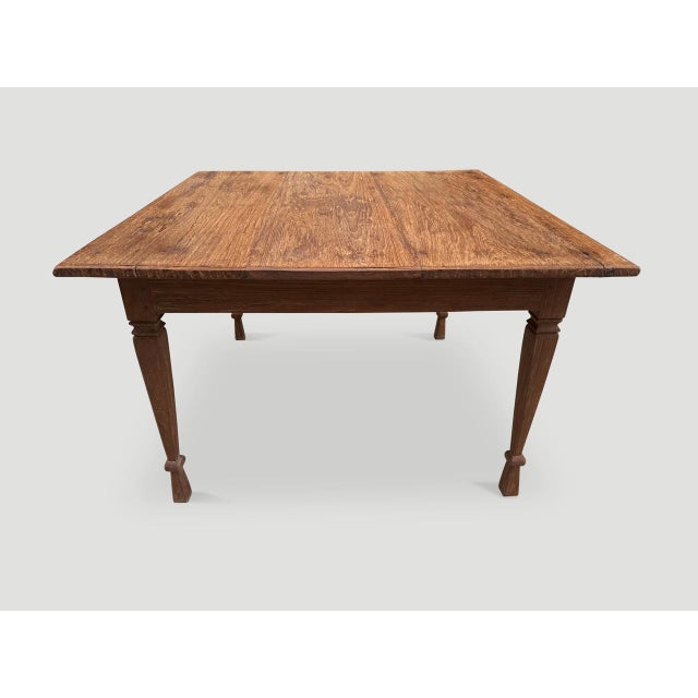 Antique teak dining table with a hand carved bevelled edge and fluted legs with beautiful patina. Perfect as a dining...