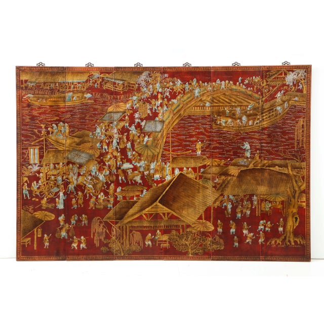 A set of six chinoiserie panels lacquered in a deep red with accents of gold and teal blue. This work of art depicts a...