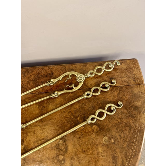 Fine quality antique Edwardian brass fire irons and fire dogs, having a quality set of three brass fire irons comprising...