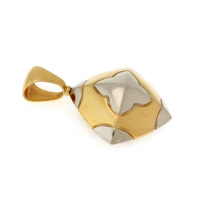 This lovely authentic pendant is by Bvlgari, it is crafted from 18k yellow and white gold featurin a pyramid style with a...