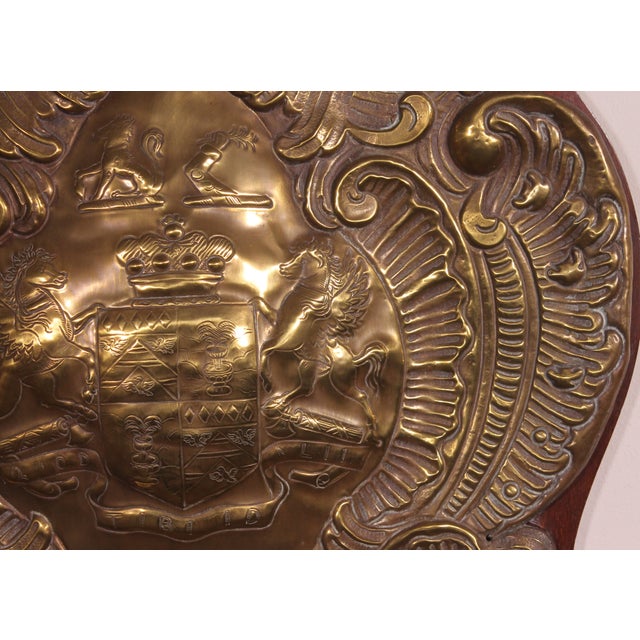 superb copper wall pannel representing the coat of arms of a 19th century English noble family It rests on a mahogany...