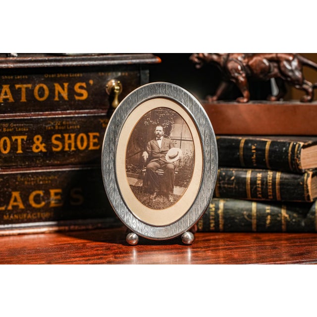 Elevate your space with this stunning antique sterling silver oval picture frame, a true treasure from circa 1910. The...