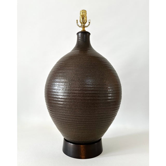 Single extra large hand thrown stoneware lamp on turned wood base. Attrtibuted to Bob Kinzie for Affiliated Craftsmen,...