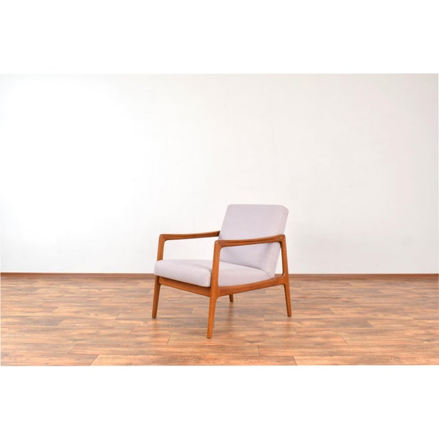 This armchair was designed in the 1960s by Alf Svensson and manufactured by Dux. The wooden frame of the armchair is made...