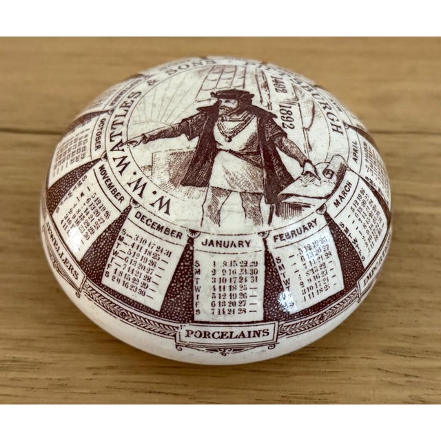 Antique ceramic advertising calendar paperweight made in France and marked G.D. Paris Depose for Georges Dreyfus on the...