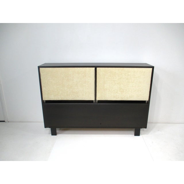 A full size upholstered headboard with tilting and sliding out backrests that reveal a storage area for bedding , books...