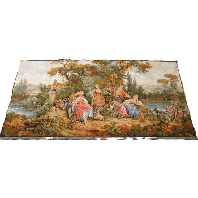 French tapestry depicting a country scene with musician and flower girl on the riverside. Background displaying a landmark...