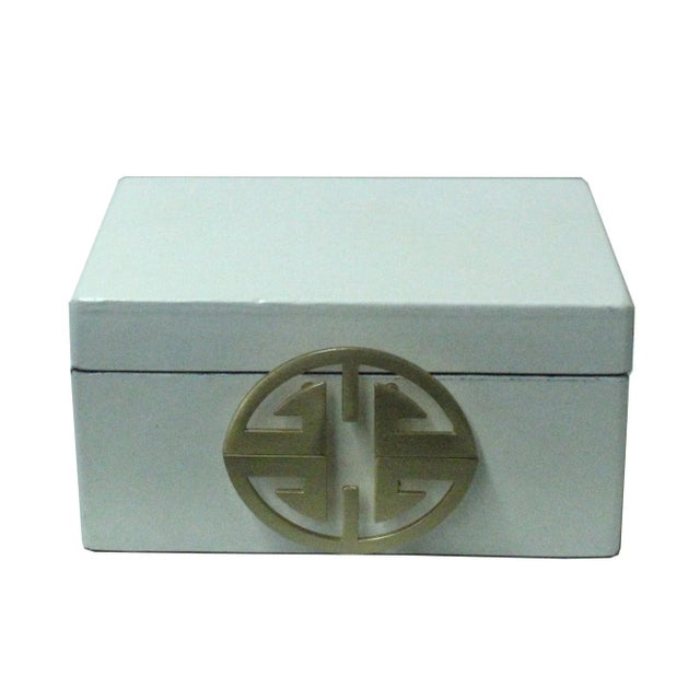 This is a decorative box in a rectangular shape and matte golden color round hardware accent. The surface is a layer of...