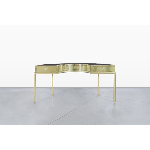 Allow me to introduce you to the exquisite Demi Luna desk, a stunning piece designed by Mastercraft in the United States....