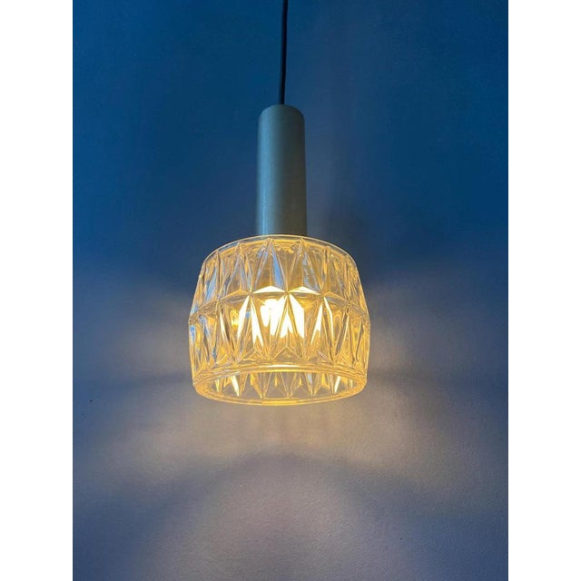 Mid century crystal glass pendant lamp by Hillebrand. The light escapes beautifully through the glass structure. The lamp...