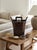 A Note for the Curators: This example retains all three original components (bucket body, octagonal lid, and carved slide-...