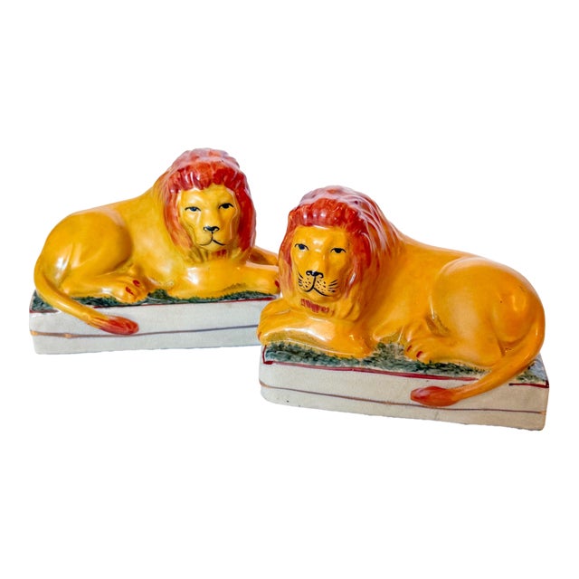 Antique Staffordshire Recumbent Lion Figurines on Rectangular Plinths - A Pair For Sale