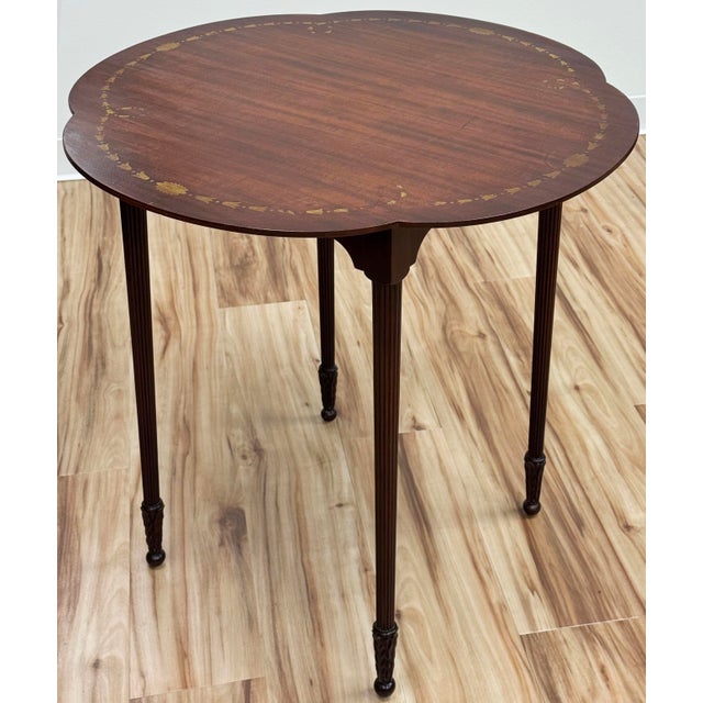 Beautiful antique scalloped mahogany wood accent table in Federal or Hepplewhite style. Slender, tapered legs with a...