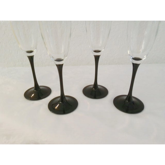 Lovely set of four vintage crystal long-stemmed champagne flutes in black. Marked underside "France." Excellent condition.