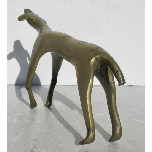 A brass figure of North African origin or Egyptian. Lost wax cast of fine brass, which is chased by bit points with a...