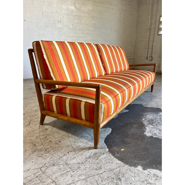 Mid century modern sofa by T.H. Robsjohn Gibbings for Widdicomb. This fabulous piece features rounded edge beech wood...