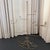 This mid-century millinery display stand showcases a striking, architectural silhouette crafted from slender braided metal...