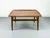 Organically shaped, square coffee table made of teak. The distinctive features include the raised edges on the sides and...