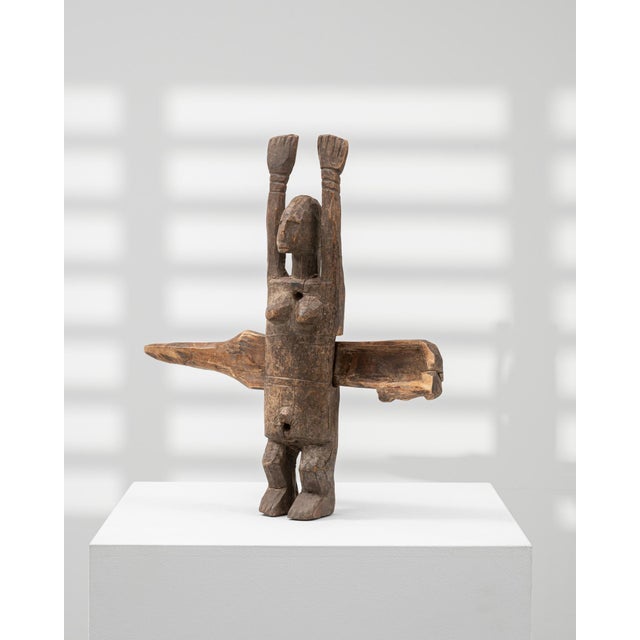 This 1950s African wooden figure embodies expressive craftsmanship and cultural symbolism. Hand-carved from solid...